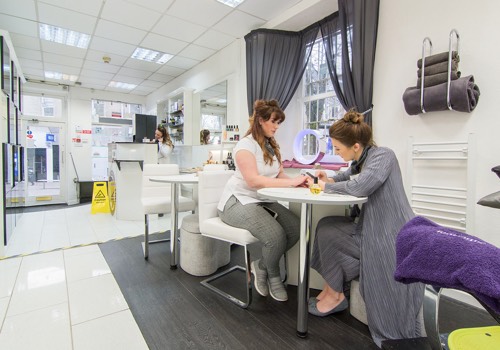 girl getting nails done in nail salon